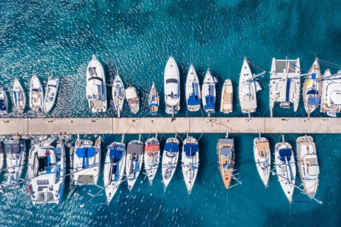 Aerial view of sailing yachts in a marina.