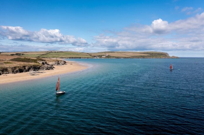 Red-sailed boats on the Camel Estuary, Cornwall Red-sailed boats on the Camel Estuary beside the beach near Padstow, Cornwall.