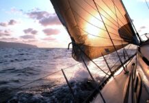 Your First Overnight Sail: How to Prepare as Crew Yacht sailing into the evening sun.